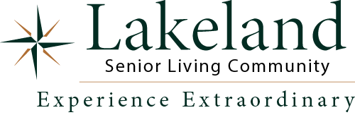 Logo for Lakeland Senior Living Community featuring a star design on the left, with the text “Lakeland Senior Living Community” above the line, and “Experience Extraordinary” below.