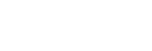 Logo of "The Lodge" senior living community. Features a green and orange compass star on the left, with the text "The Lodge" in large font, "Senior Living Community" below it, and "Experience Extraordinary" at the bottom.