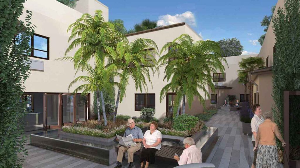 A serene courtyard with palm trees surrounded by modern buildings. Seniors sit on benches and read in the foreground. The area is paved with light gray tiles, and the sky is clear with a few clouds.