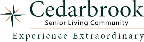 Logo for Cedarbrook Senior Living Community with a green compass symbol on the left and the tagline "Experience Extraordinary" written below in green capital letters.